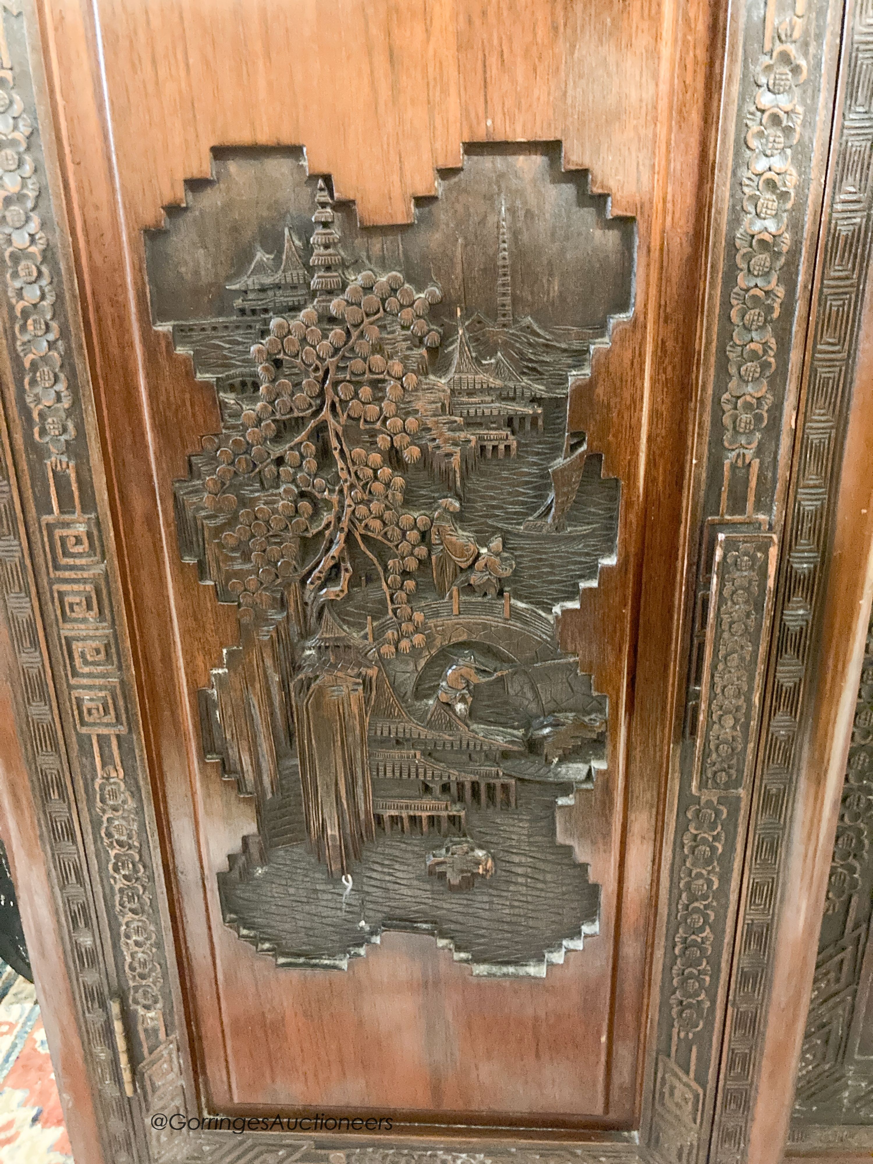 A Chinese carved hardwood breakfront display cabinet, glazed door, length 152cm, depth 33cm, height 112cm